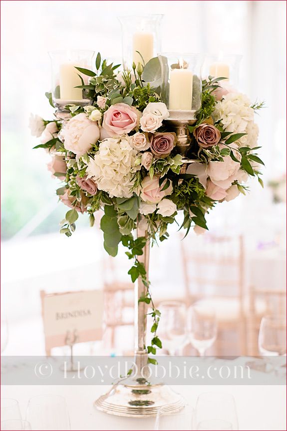 Stunning tall floral centerpieces with candles. Such a romantic centerpiece  idea!