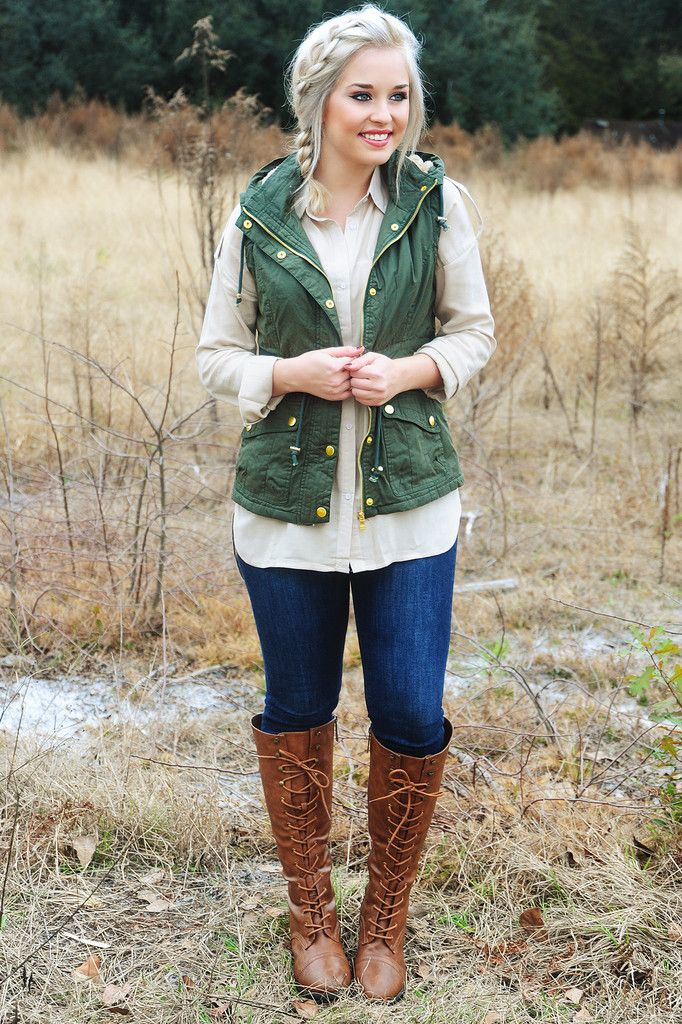 Army green vest, beige chiffon button down, skinny jeans, brown riding boots