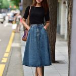 Pair a fitted denim skirt with a loose cropped blouse. Or, go with a fitted  top in an eye-catching pattern to balance out the mass of solid denim on  the