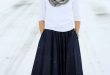 Full navy midi skirt paired with black ankle boots and sweater