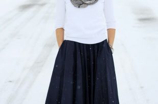 Full navy midi skirt paired with black ankle boots and sweater