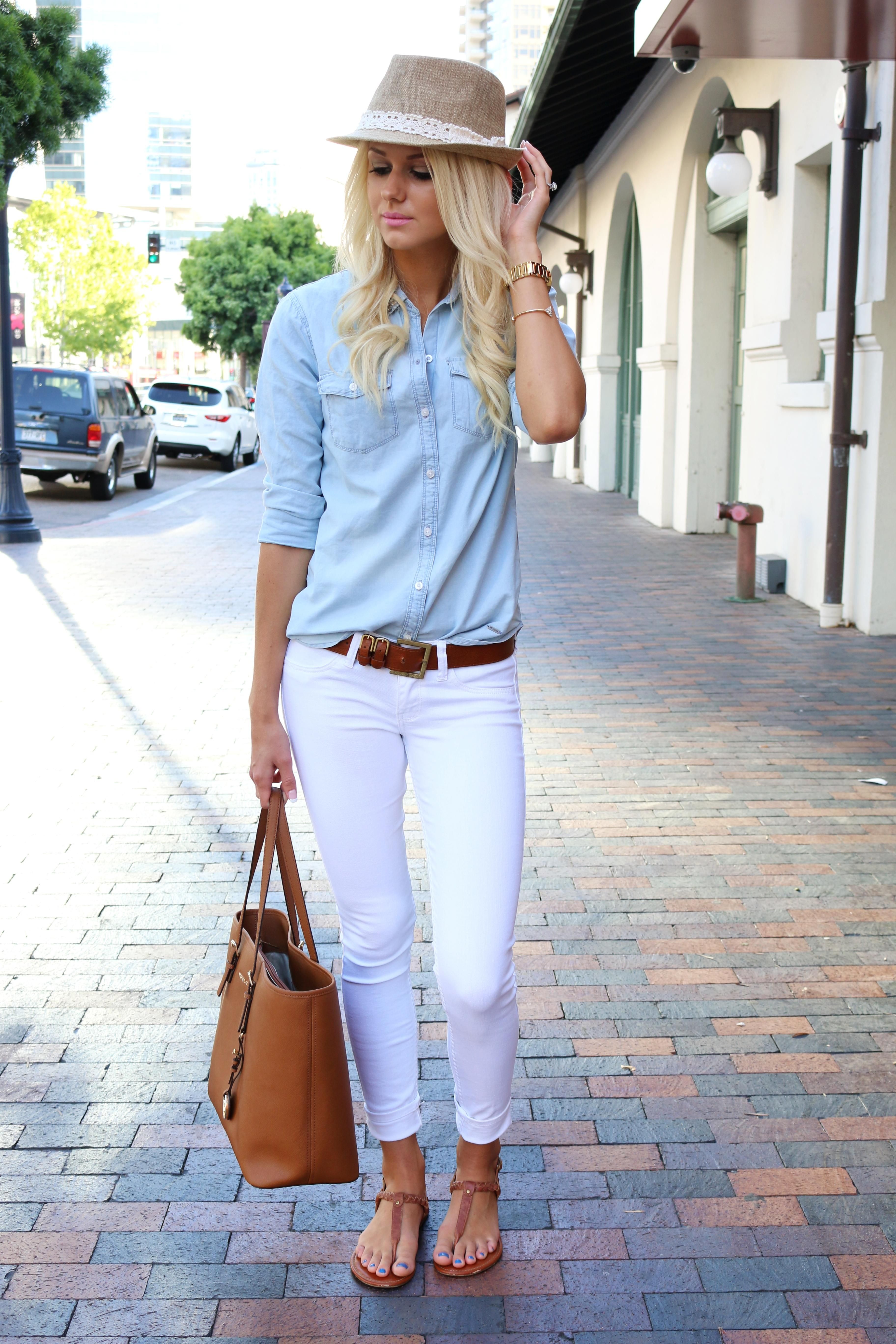 Summer Outfit Idea: White Jeans - chambray shirt tucked into belted  low-rise white jeans, worn with brown sandals + a lace embellished fedora