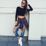 26 Great Fall Outfits: Ideas To Try Already This Autumn/Winter Season: Woman  wearing ripped blue jeans, black crop top, plaid shirt and white Converse