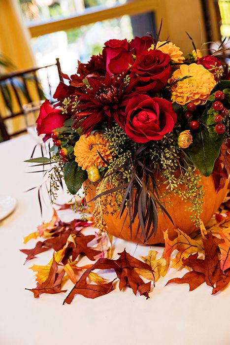 Add a hint of Halloween to your wedding reception with pumpkin floral centerpiec…